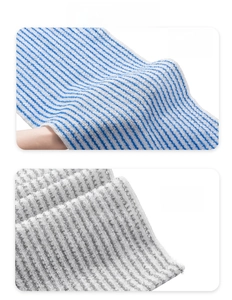Detail shot of blue striped soft texture and grey exfoliating mesh bath towels