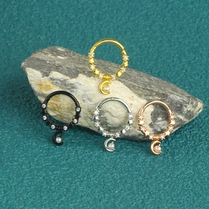 316L stainless steel moon and pearl nose rings set in four metallic finishes on stone