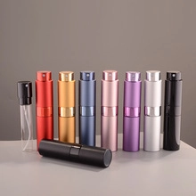 Macro shot of 10ml twist-up perfume atomizers in assorted colors with glass inner bottle