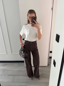 Women's high waist wide leg jeans in dark brown styled with a white ruffled pocket t-shirt