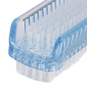 Detail of the blue medical scrub brush with soft white bristles for nail cleaning