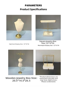 Detail of linen bust and gold metal jewelry display stands for necklaces and earrings