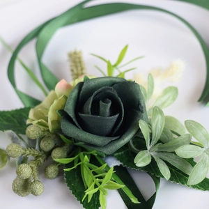 Dark green PE rose boutonniere with decorative ribbons and berries for wedding events