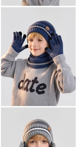 Detail of knit hat leather logo and touchscreen fingertips on winter gloves set