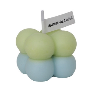 Green and blue handmade bubble cube candle in a stack design on a clean white background