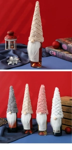 Detail of colorful knitted Christmas gnome wine bottle covers with soft faux fur beards