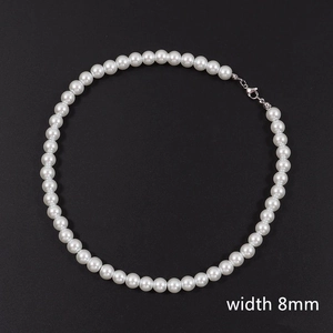 Detail of 8mm white faux pearl necklace with metallic lobster clasp on black background