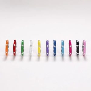 Row of colorful enamel rings with inset cubic zirconia on a clean white background