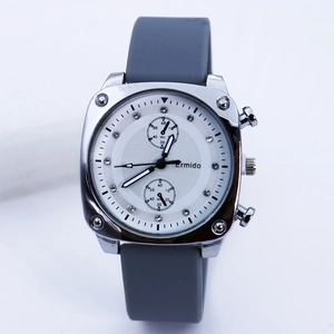 Detailed view of Ermido square silver watch with crystal markers and grey silicone strap
