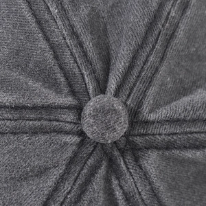 Macro shot of the dark grey cotton baseball cap crown with thick stitching and top button