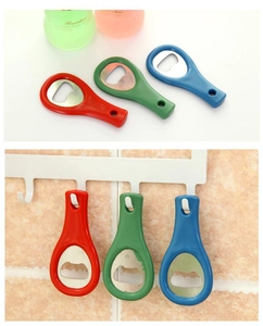Close-up of colorful tennis racket bottle openers hanging on a wall for easy storage