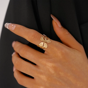 Detailed close-up of a gold-plated flower ring showing intricate hollow-out texture