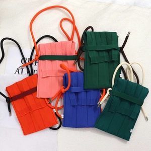 Detailed knit texture and vibrant accordion pleats of five mini phone crossbody bags