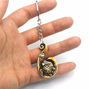 Maori style turtle and fish hook resin keychain with imitation bone finish detail