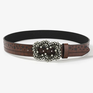Detailed macro view of brown punk belt with star cutouts and a luxury rhinestone buckle