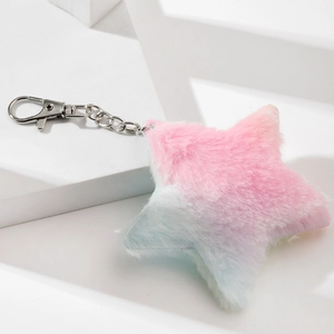 Macro detail of star-shaped plush keychain with pink and blue gradient fur and silver metal clasp
