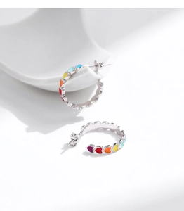 Detailed close-up of S925 silver half-hoop earrings featuring colorful rainbow enamel hearts