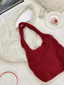 Minimalist oversized plush tote bags in red wool and tweed fabric with a wide shoulder strap