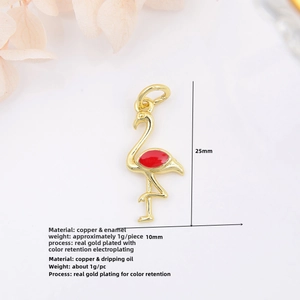 Macro shot of 18k gold-plated flamingo pendant with red enamel for DIY jewelry making
