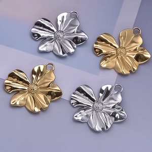 Detailed macro of gold and silver flower pendants with hammer-textured 304 stainless steel