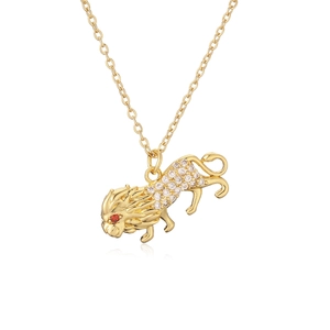 Golden lion head pendant necklace with clear crystals and red gemstone eyes on white background