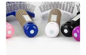 Macro shot of curved hairbrush handle with textured grip in multiple vibrant colors