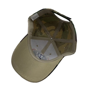 Detail view of camouflage baseball cap showing inner lining and 100% acrylic label