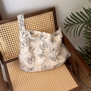 Detailed texture of lace butterfly pattern and frayed edges on beige shoulder tote bag