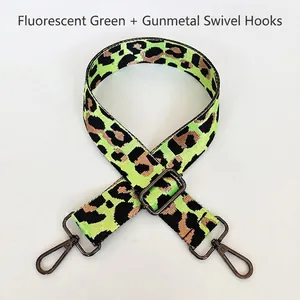Close-up of neon green leopard nylon bag strap with gunmetal adjustable hardware