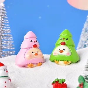 Christmas cartoon resin bird figurines in tree outfits set on a snowy landscape