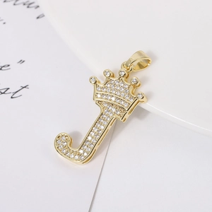 Macro shot of gold-plated J letter pendant with crown detail and micro-paved zircons