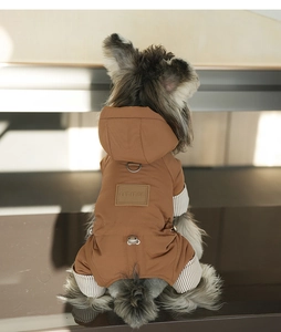 Detail of coffee pet jacket featuring leather patch and striped ribbed cuffs