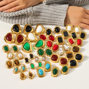 French vintage stainless steel earrings with gold frames and colorful stones on white background