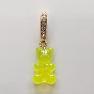 Detailed close-up of a fluorescent yellow resin gummy bear pendant with a gold rhinestone loop