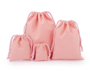 Detail of pink velvet drawstring storage pouches in four different sizes for packaging