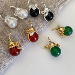 Detail of elegant gourd-shaped earrings with gold plating, zircons, and colorful beads