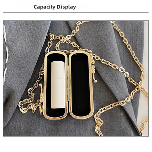 Macro view of golden mini clutch interior showing lipstick storage and black velvet lining