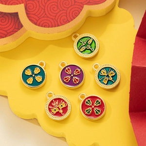 Detail view of round enamel medical pendants with gold trim on decorative background
