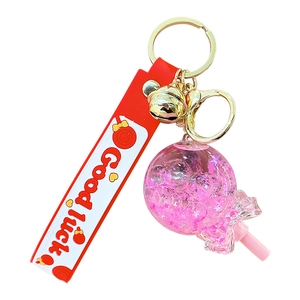 Luminous quicksand lollipop keychain with pink silicone strap and glitter liquid ball