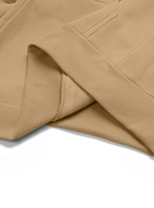Detail of camel hoodie hem showing ribbed knit texture and soft fleece lining