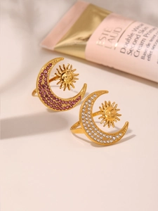 Detailed view of 18K gold sun and moon rings with sparkling zircon inlay accents