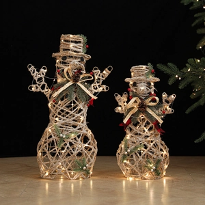 Pair of champagne straw-woven snowman table decors with warm LED lights and pine accents