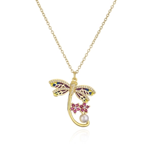 Detail of 18K gold dragonfly necklace with colorful enamel wings and a pink flower pearl