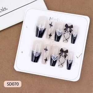 Dark aesthetic black bow and silver heart press-on nails with 3D star charms in size S