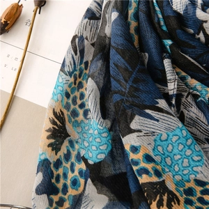 Detailed view of lightweight cotton-linen scarf with navy leaf and leopard print