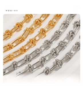 Macro shot of titanium steel knot chain bracelets in gold and silver metallic finishes
