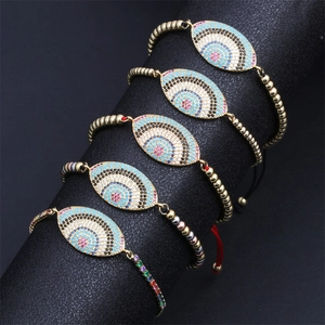 Close-up of five evil eye bracelets with colorful cubic zirconia on a black display stand