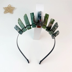 Detail of handmade crown with green and reddish-brown natural crystals and crescent moon