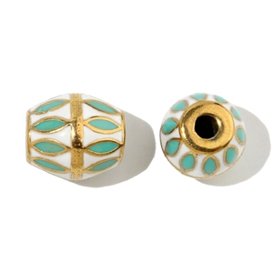 Macro view of white ceramic bead with gold trim and turquoise leaf pattern for DIY jewelry