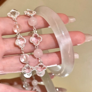 Pink clover beaded bracelet and white crystal bangle set for women shown on hand